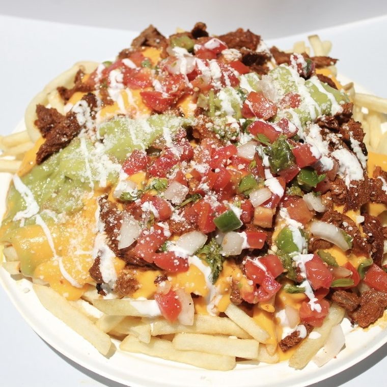 Nacho fries under asada and queso