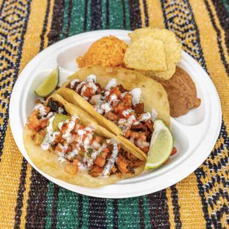 Puffy taco plate with rice, beans and chips