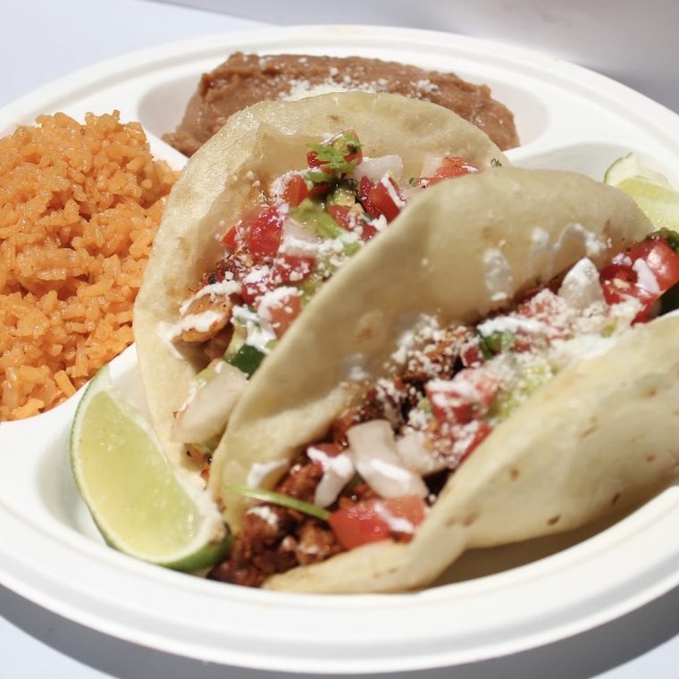 Puffy tacos with rice, beans and chips