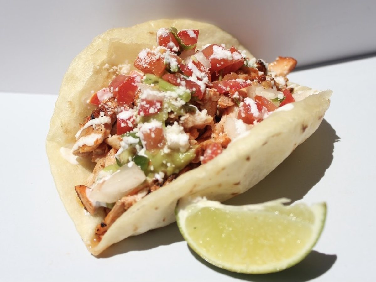Shawn’s freshly fried puffy taco with flame grilled chicken, guacamole, pico de gallo, crema and cotija cheese